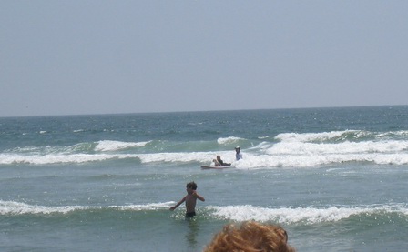 Dog and owner on a surfboard, the kid actually managed to stand up shortly after I shot this picture